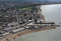 Aerial photograph showing town on left, harbour in the centre and sea on the right