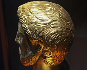 Smooth hair on a golden bust.