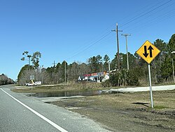 A row of colored businesses off to the right side of a highway