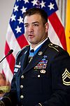 Headshot portrait of a man wearing an Army Combat Uniform and Army Ranger tan beret.