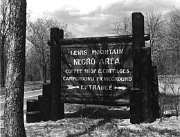 Park sign reading: "Lewis Mountain – Negro Area – Coffee Shop & Cottages - Campground Picnicground – Entrance"
