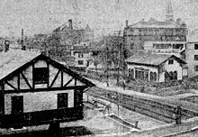 A black-and-white photo of two railway stations