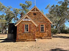 Stone school building in country setting