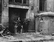Home Army soldiers from "Ruczaj" Battalion (after a fire fight for the Mała PAST building) take pictures at the main entrance at Piusa Street next to a bunker, 24 August 1944