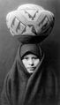 Zuni girl with pottery