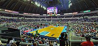 The view of the Coliseum from the Lower Box level, during the 2021 PBA season between the Barangay Ginebra San Miguel and the Magnolia Hotshots. The rivalry between the teams is often known as the Manila Clasico