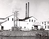 Photograph of the Samuel Elmore Cannery while it was in operation, with a "Bumble Bee" sign hanging above the door.