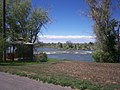 A gazebo on the greenbelt in Shelley, ID overlooks the Snake River as it flows over some rocks. This gazebo was destroyed in 2009.