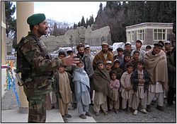 An Afghan Army captain addresses Sherzad village.