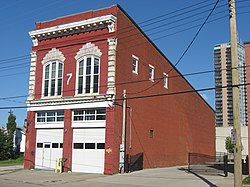 Photograph of the Steam Engine Company No. 7 firehouse, a two-story, brick building with personnel areas above and two garages below