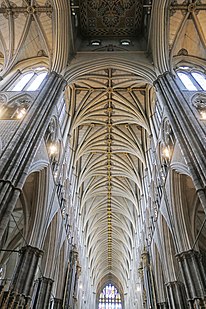 The inside of Westminster Abbey's nave, with a high vaulted ceiling.