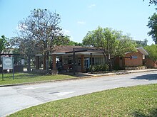 A small red-brick station house with the 1971 Amtrak logo.