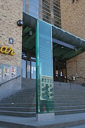 Translucent, rectangular column at the bottom of a flight of steps