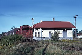 C&NW freight passing the MILW station at Stiles Junction, WI, in September 1964