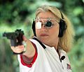 Elizabeth Callahan wearing shooting glasses with an iris diaphragm as a visual aid at a 25 m pistol event.