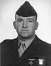 A black and white image showing the head and upper torso of Taylor in his military dress uniform with ribbons and hat.