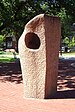 Granite sculpture consisting of a rough-hewn rectangular pillar enclosing a more polished rectangular internal structure
