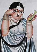 A lady applying kohl