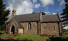 Exterior of St John's Church showing short tower and surrounding graveyard