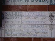 A tablet formed of five tiles of varying sizes, bordered by yellow and blue flowers in an art nouveau style