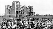 School exterior with group photo of students