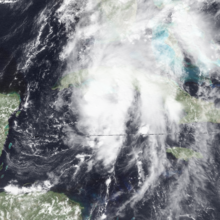 A tropical storm with an apparent overall circulation pattern, but the convection is not particularly well-organized, with several blobs and a couple relatively straight bands