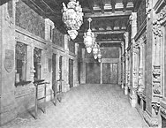 Black-and-white picture of the theater's original lobby. There are ticket booths and elevators to the left; the ticket booths are in the foreground, while the elevators are in the background.