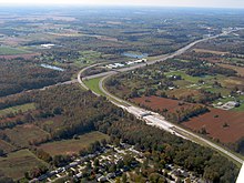 Aerial view of a divided highway and several ramps that lead into a toll plaza