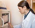 A laboratory worker reviews sensitivity results displayed on the screen of the automated analyzer.