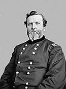 Black and white photo of a heavy-set, bearded man. He wears a dark military uniform with two rows of buttons and the two stars of a US major general on the shoulder tabs.