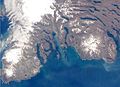 The southern part of the Kerguelen Islands, with Mont Ross at right (white spot, top of image is north) and on the left, the Glacier Cook (white spot) and the Peninsula Rallier du Baty.