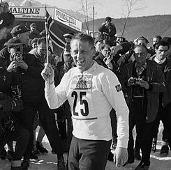 Man in skiing gear and number 25 on shirt being photographed