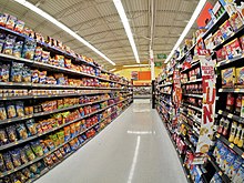 Junk food lines both sides of tall shelves at a grocery store