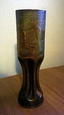 WWI trench art with etchings of a horse and horse shoes on an 80 mm shell casing.