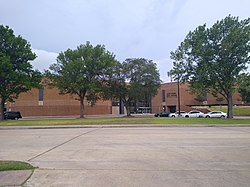 Brutalist building with a sign reading "Alief Elsik High School"