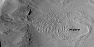Glacier on a crater floor, as seen by HiRISE under HiWish program The cracks in the glacier may be crevasses. There is also a gully system on the crater wall.