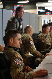 Soldiers at a table in the 2023 Indo Pacific Virtual Flag exercise, hosted by the American military