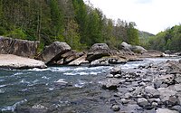 Light rapids of a river between rocky riverbanks