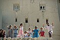 A beaming crowd of children in front of an old mud house. Yemen. 1972