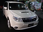 Subaru Forester tS, a high-performance variant of the standard Subaru Forester. This photo shows the front of the car, which is white; there is a "tS" badge on the front grille which stands for "tuned by STI".