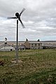 A wind turbine and houses