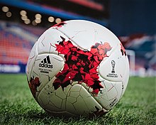 Football made of sewn together X shaped panels with a painted stylised small X in the middle of the panel. Also Printed on the ball is the name and logo for both Adidas and confederation cup 2017.