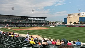 A green baseball field surrounded by a seating bowl