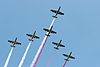 Polish military aircraft flying in formation during a Polish Armed Forces Day parade