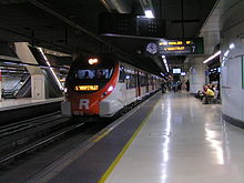 A Civia train in Rodalies de Catalunya livery making a service on Barcelona commuter rail service line R7 at Barcelona Sants railway station in 2011.