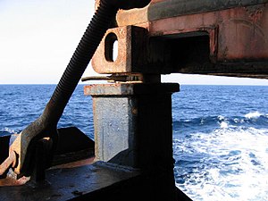 Twistlock engaged with shipping container at sea