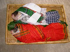 The groom's family members often bring fish decorated as a wedding couple to the bride's Gaye Holud