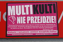 A pink poster in Polish with headline MULTIKULTI / (thumb down) NIE PRZEJDZIE! ("multiculti will not pass!")