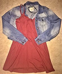 a salmon-coloured slip dress and distressed denim jacket