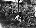 Hitler sitting at far right among soldiers of the "List" regiment and Fuchsl. From left to right, standing: Sperl (Munich), lithographer (?), Max Mund (Munich), gilder; Left to right, sitting: Georg Wimmer (Munich), tram worker, Josef Inkofer (Munich), Lausamer (killed in action), Adolf Hitler; In front: Balthasar Brandmayer (Bad Aibling), bricklayer.